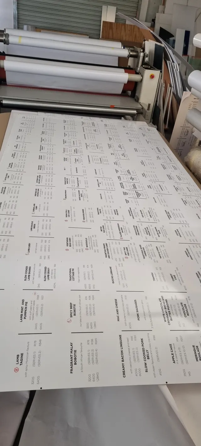 Price-board sheet aligned on the CNC machine for cutting