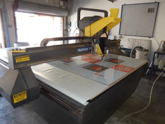 CNC router and printed sheet on the Sunata workshop cutting bed