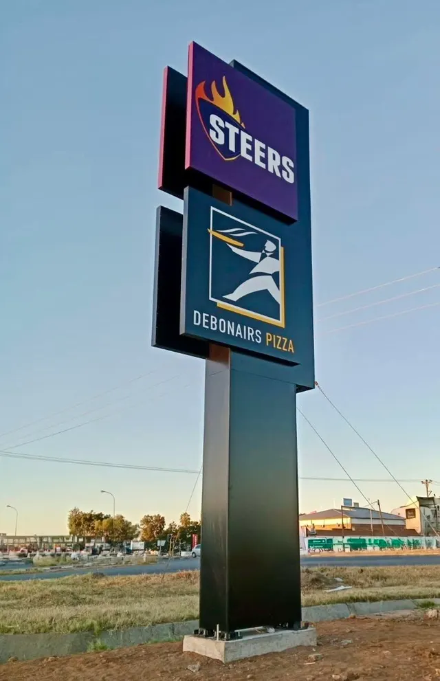 Multi-brand roadside pylon with Steers and Debonairs signage at Palapye