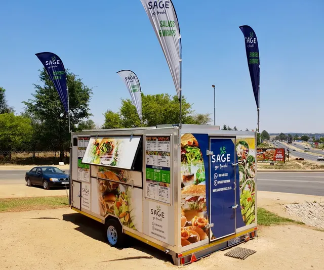 Printed food imagery across the Sage Food Truck trailer wrap