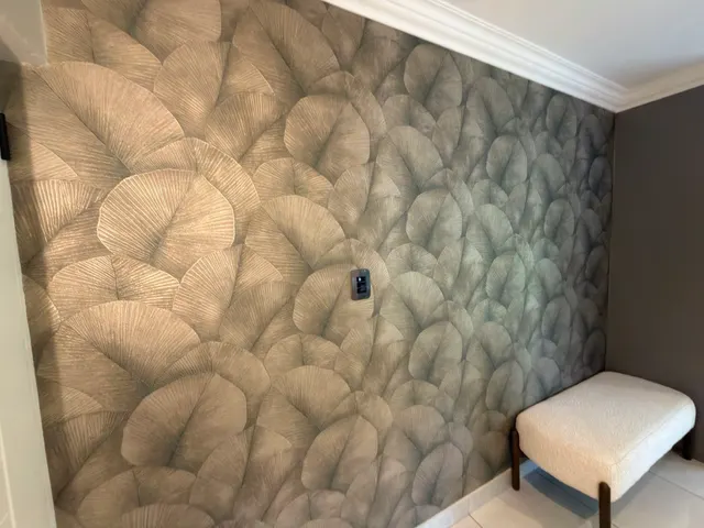 Leaf-pattern wallpaper meeting an interior corner