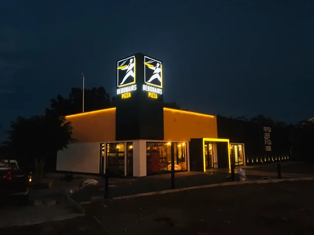 Debonairs illuminated shopfront from the side