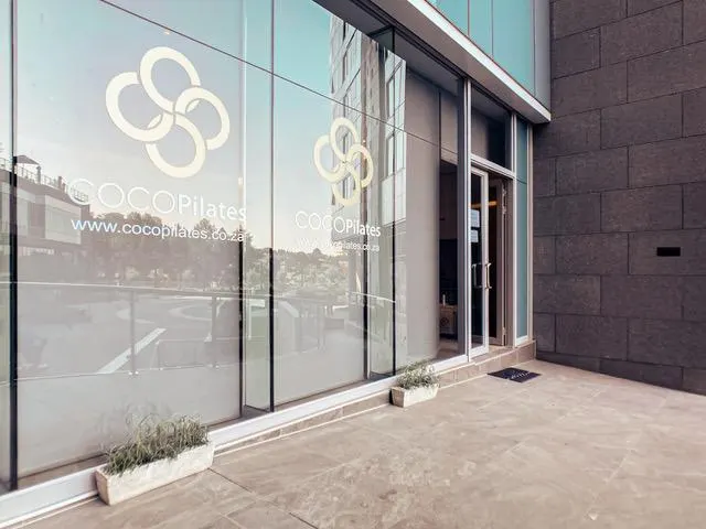Coco Pilates branding across the studio entrance glazing