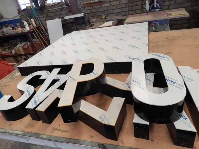 Dimensional fabricated letters laid out for production
