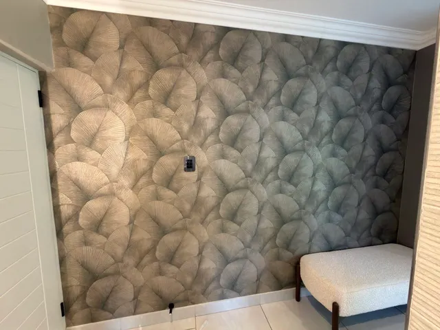 Feature-wall wallpaper finished around the room corner and bedside area