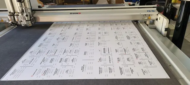 Printed Frozen for You price-board sheets on the CNC cutting bed